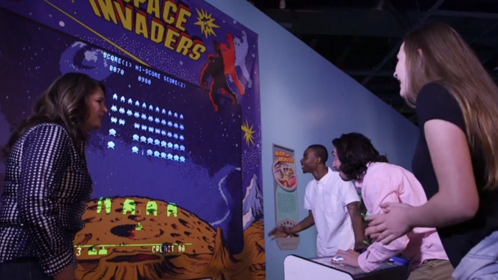 People playing Space Invaders at The Strong
