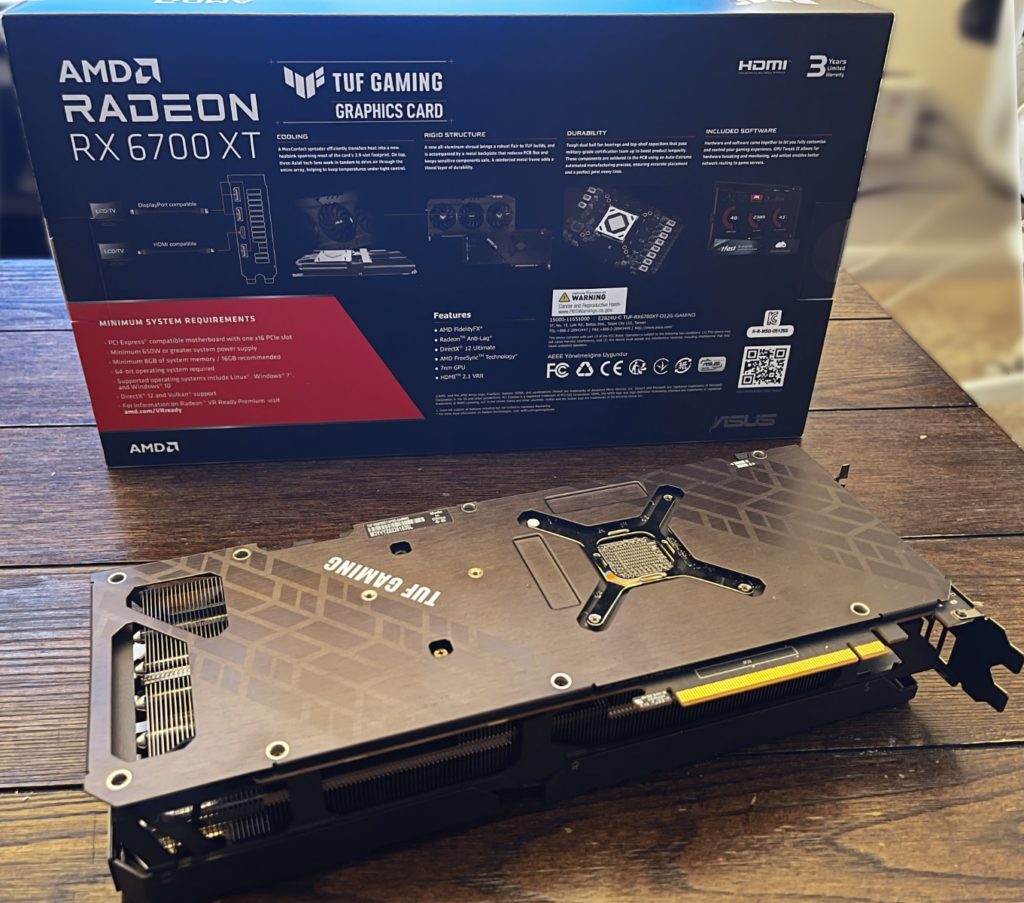 ASUS TUF Gaming Radeon™ RX 6700 XT OC Edition Backplate and Rear of Box on hardwood table